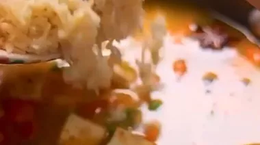 Phulkari Pulao with saffron rice, nuts, peas, and paneer served in a brass bowl 6